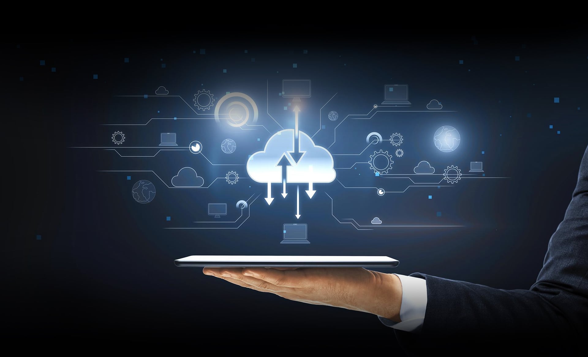 An open hand holding a tablet at chest height, a luminous cloud above it exchanging arrows with a circuit diagram of laptops, monitors, globes and gears drawn in fine grey line work.