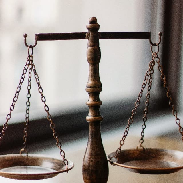 A pair of brass weighing scales in balance.
